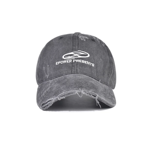 Detail shot of distressed cotton baseball cap with white embroidery and frayed brim