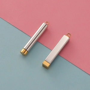 Detail of silver and gold stainless steel cylindrical and square pendant accessories