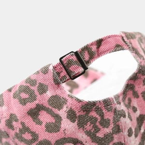 Detailed close-up of pink leopard print cap showing the adjustable black buckle strap