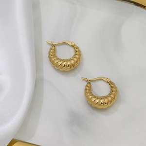 Chic 18K gold plated stainless steel croissant hoop earrings for women on marble