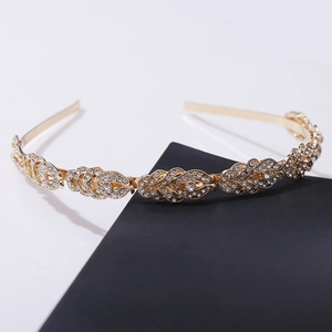 Elegant gold metal leaf headband with sparkling rhinestones for wedding hair styling