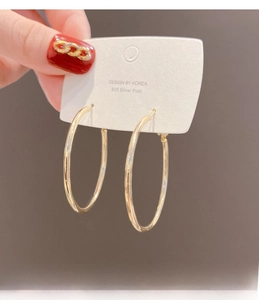 Detail of large gold hoop earrings with hypoallergenic 925 silver posts for women
