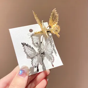 Golden and silver butterfly hair clips with tassels and 4cm length on card display