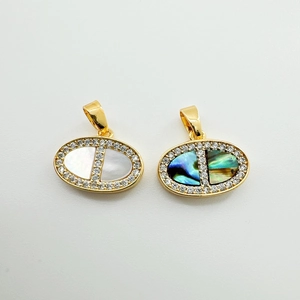 Detailed view of gold oval pendants with natural abalone shell and white mother of pearl