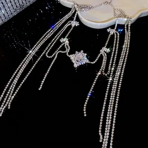 Silver zircon tassel necklace featuring a flower pendant on a reflective black surface