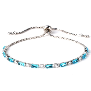 Detail of adjustable silver bracelet featuring blue rectangular gems and round zircons
