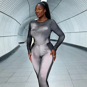 Close-up of grey gradient printed long sleeve slim fit bodysuit in subway setting