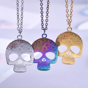 Gothic hollow skull necklaces with floral engraving in silver, gold, and rainbow colors