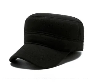 Detail of black wool winter military cap featuring a classic gold shield metal badge