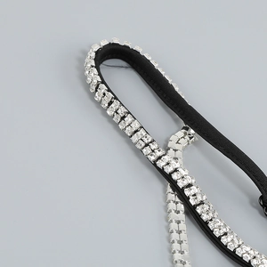 Macro view of sparkly square rhinestones on a black elegant dress strap detail