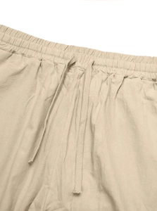 Detail of men's linen pants featuring elastic waistband and adjustable drawstrings