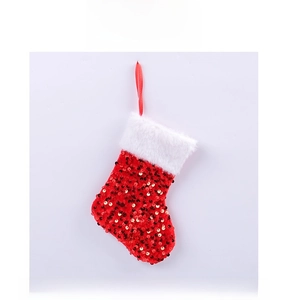 Detail of red and gold sequin Christmas stocking with white plush cuff and hanging loop