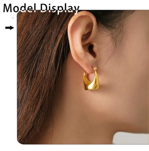 Close-up model display of thick U-shaped 18K gold plated PVD stainless steel earrings