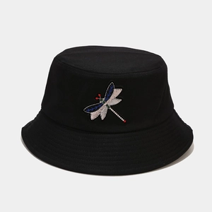Detailed close-up of colorful dragonfly embroidery on black cotton bucket hat