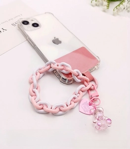 Close-up of pink resin chain phone strap with a heart tag and small bear charm