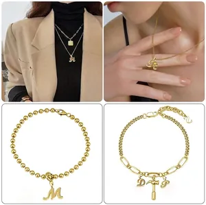 Golden alphabet pendant jewelry set with layered necklaces and letter charm bracelets