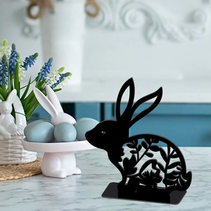 Detail of a black hollow rabbit desktop ornament on a marble surface for Easter decor