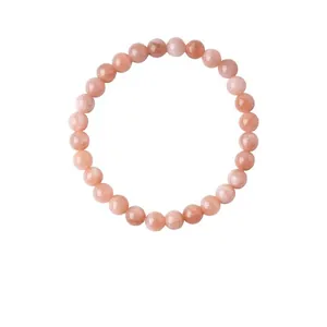 Detailed view of natural sunstone beaded bracelet with elegant pink hues on white background