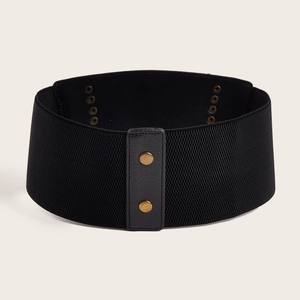 Elastic black wide waist belt with faux leather snap buttons on beige background