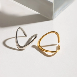 Macro view of adjustable wave rings in gold and silver finish with polished surface