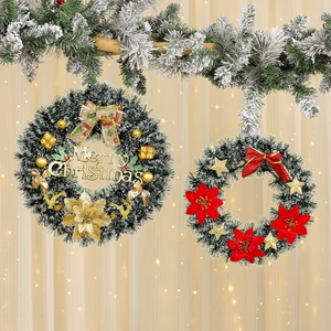 Classic green Christmas wreaths with gold and red poinsettias and festive decorations