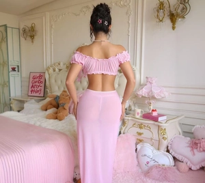 Detail view of pink off-shoulder mesh top and sheer chiffon maxi skirt from behind