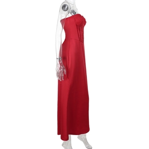 Detail of red satin backless dress featuring intricate lace stitching and corset bodice