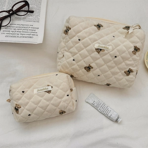 Quilted corduroy toiletry bags with bear embroidery and zip closure in creamy beige