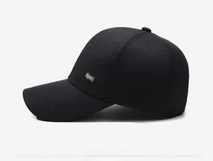 Detail of black twill baseball cap showing side sport metal plate and textured fabric