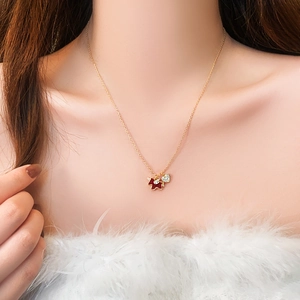 Gold plated necklace featuring a red bear pendant and a heart-shaped zircon stone
