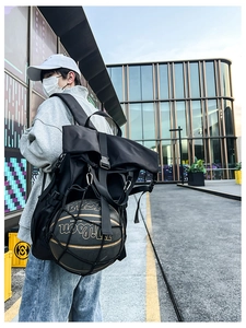Outdoor view of a black basketball backpack featuring a mesh net for ball storage