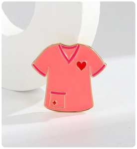 Detailed macro view of pink enamel nurse uniform brooch with red cross and heart accents