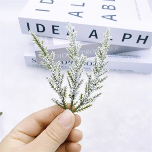 Detail of artificial pine needle branch with realistic flocked snow for Christmas decor
