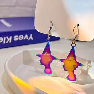 Macro shot of iridescent witch silhouette earrings with colorful gradient plating and gold hooks