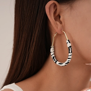 Fashionable oversized hoop earrings with zebra print texture and gold metal accents
