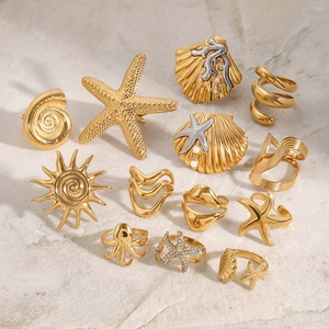 Golden ocean theme titanium steel ring set with starfish shells and pearls on marble