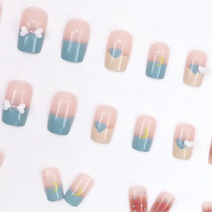 Cute French press-on nails with blue-pink bows, moon accents and heart designs