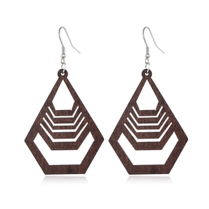 Detail view of hollow geometric wooden earrings in dark brown with metal hooks