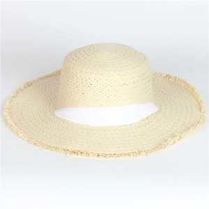 Close-up of the natural straw weaving texture and fringed brim on this summer sun hat