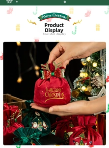 Close-up of velvet Christmas gift bag with golden antlers and Merry Christmas print