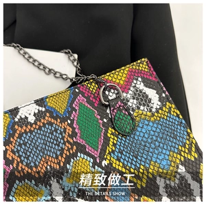 Close-up of vibrant multi-color snakeskin texture and high-quality black metal chain strap
