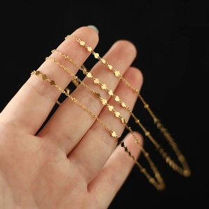 Detailed macro view of 18K gold plated heart choker with delicate beads and sequins