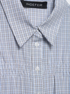 Detail of blue and brown checkered stretch poplin shirt with pearl buttons and stitching