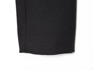 Close-up of black twill fabric texture and neat stitching on vintage suit jacket