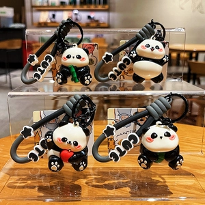 Cute UV plated cartoon panda keychains set in various poses displayed on a stand