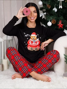Close-up of black Christmas pajama top with cute holiday bear print and plaid lounge pants