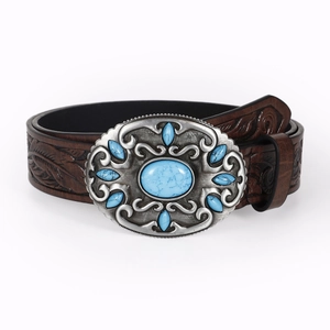 Close-up of brown embossed leather belt with a vintage silver buckle and turquoise stone