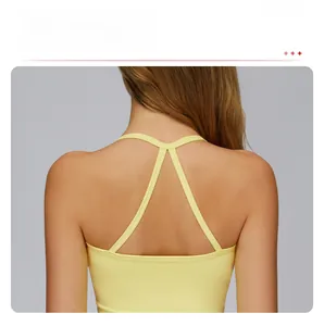 Close-up of the cross-back strap design on this lemon yellow women's yoga sports vest