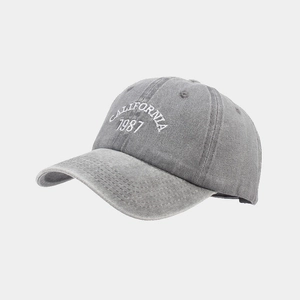 Detail of embroidered CALIFORNIA 1987 text on washed cotton grey baseball cap