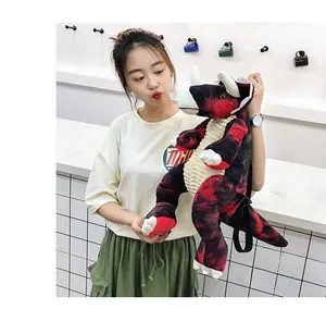 Detail of red and black tie-dye dinosaur plush backpack with adjustable straps